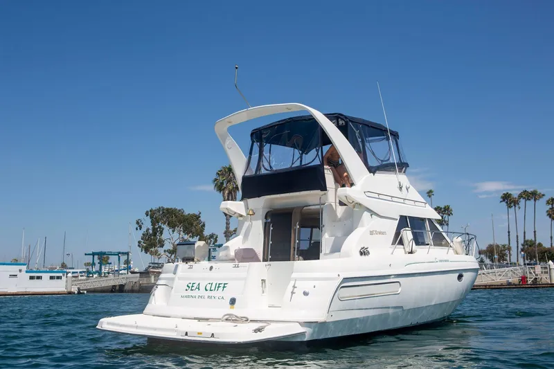 Slide: The Image of 1996 CRUISERS YACHTS 3580 Flybridge on water, Marina del Rey backdrop. - 1