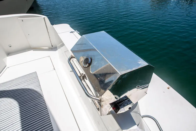 Slide: The Image of Stainless steel grill on 1996 CRUISERS YACHTS 3580 Flybridge, docked by the water. - 12