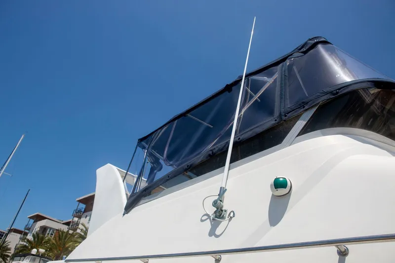 Slide: The Image of 1996 CRUISERS YACHTS 3580 Flybridge with clear canopy under blue sky. - 14