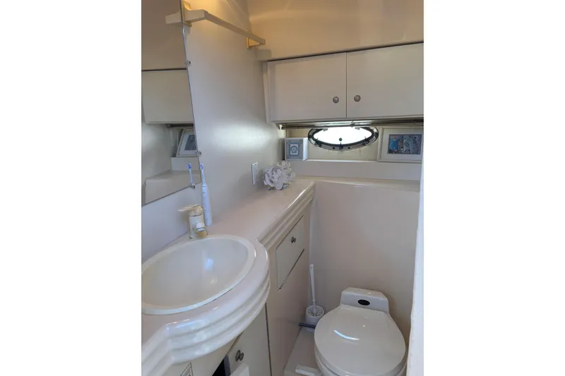 Slide: The Image of Bathroom interior of 1996 Cruisers Yachts 3580 Flybridge with sink and toilet. - 60