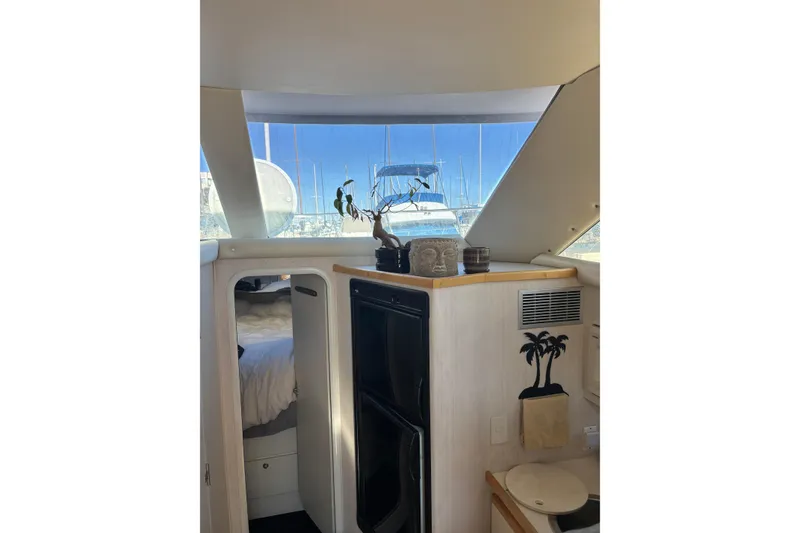 Slide: The Image of Interior of 1996 Cruisers Yachts 3580 Flybridge with bed, decor, and marina view. - 61