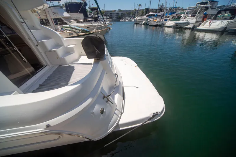 Slide: The Image of 1996 CRUISERS YACHTS 3580 Flybridge docked in a marina, showcasing sleek design and spacious deck. - 21