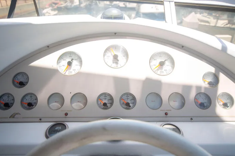 Slide: The Image of 1996 CRUISERS YACHTS 3580 Flybridge dashboard with gauges and controls. - 38