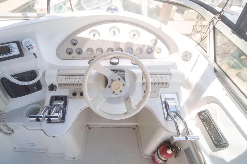 Slide: The Image of 1996 Cruisers Yachts 3580 Flybridge helm with steering wheel and control panel. - 41