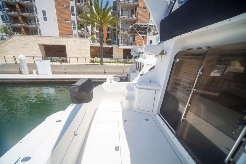 Slide: The Image of 1996 CRUISERS YACHTS 3580 Flybridge docked, showcasing spacious deck and modern marina backdrop. - 18