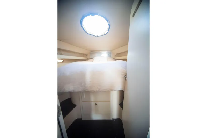 Slide: The Image of Cozy cabin interior of 1996 Cruisers Yachts 3580 Flybridge with bed and porthole. - 53