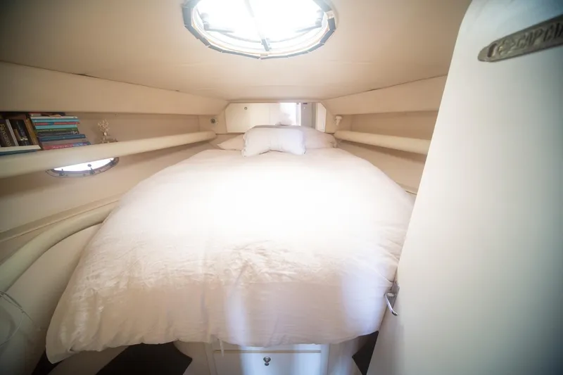 Slide: The Image of Cozy cabin interior of 1996 CRUISERS YACHTS 3580 Flybridge with bed and books. - 52