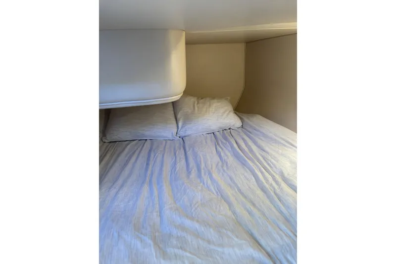 Slide: The Image of Cozy cabin bed inside 1996 Cruisers Yachts 3580 Flybridge, featuring soft pillows and bedding. - 62