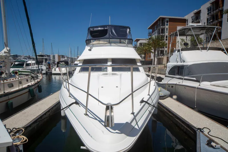 Slide: The Image of 1996 CRUISERS YACHTS 3580 Flybridge docked at marina, surrounded by other boats. - 26