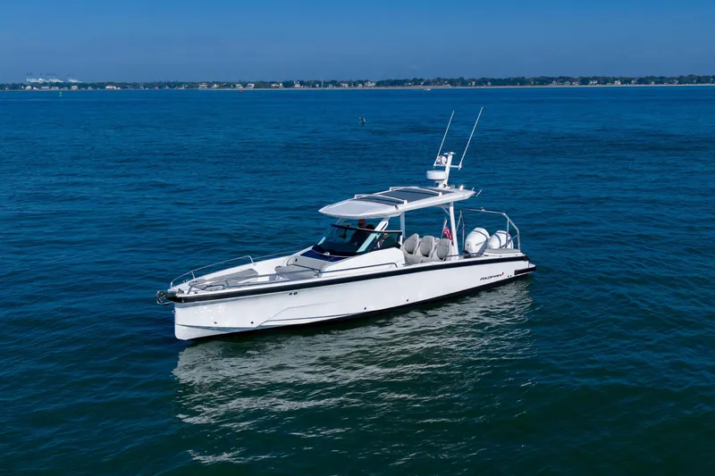 Slide: The Image of 2027 Axopar 29 Sun-Top boat cruising on open blue water. - 6