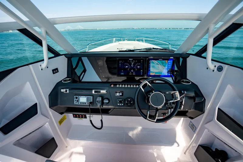 Slide: The Image of Cockpit of 2027 Axopar 29 Sun-Top boat with modern navigation system and steering wheel. - 17