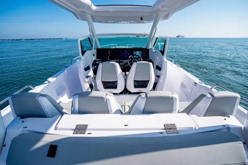 Slide: The Image of 2027 Axopar 29 Sun-Top boat interior with modern seating and ocean view. - 13