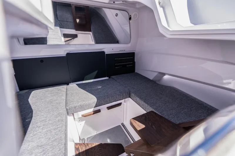 Slide: The Image of Interior cabin of 2027 Axopar 29 Sun-Top boat with gray seating and modern design. - 19