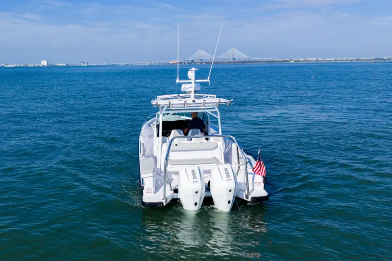 Slide: The Image of 2027 Axopar 29 Sun-Top boat cruising on open water with dual engines. - 4