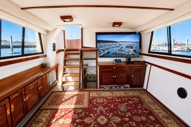 Slide: The Image of Luxurious interior of 1983 Silverton 402 Motor Yacht with elegant wood finishes and marina view. - 12