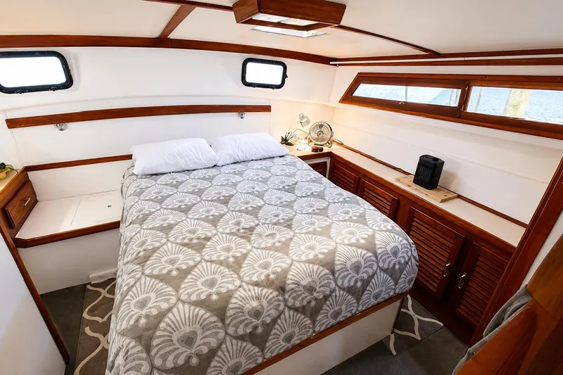 Slide: The Image of Cozy bedroom in 1983 Silverton 402 Motor Yacht with elegant wood accents and patterned bedding. - 21