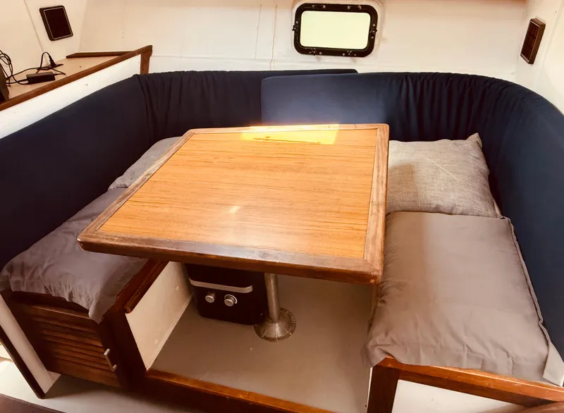 Slide: The Image of 1983 Silverton 402 Motor Yacht interior with wooden table and cushioned seating. - 20