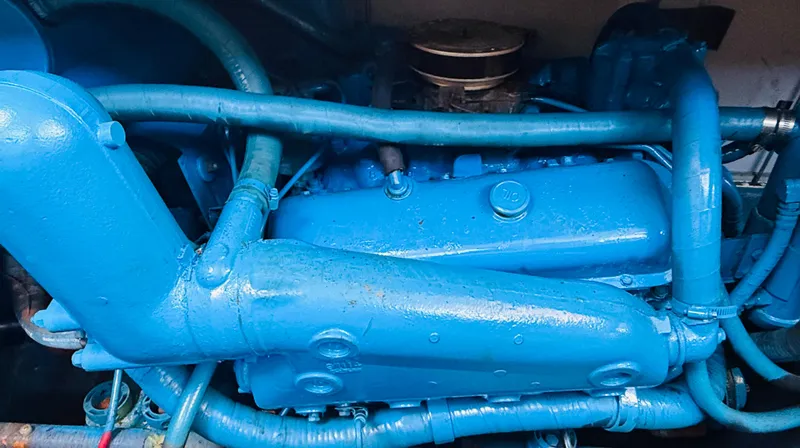 Slide: The Image of Engine of a 1983 Silverton 402 Motor Yacht, painted in bright blue. - 32