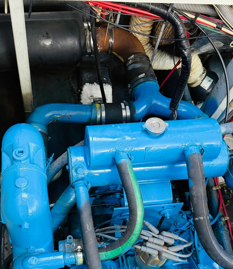 Slide: The Image of Engine compartment of a 1983 Silverton 402 Motor Yacht with blue components and wiring. - 30