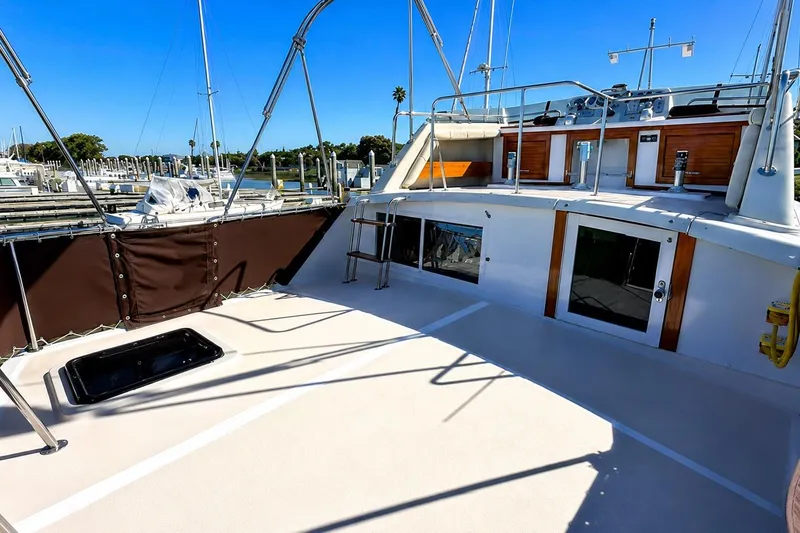 Slide: The Image of 1983 Silverton 402 Motor Yacht deck with railing and marina view. - 5