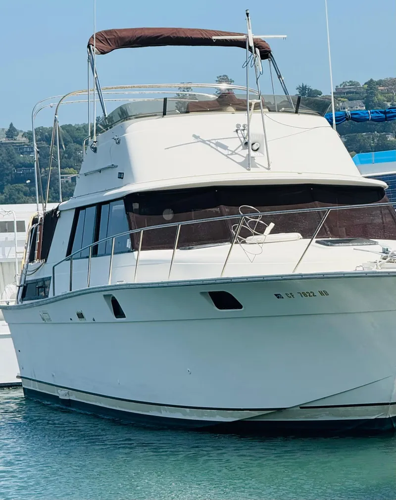 Slide: The Image of 1983 Silverton 402 Motor Yacht docked in a marina, featuring a classic design. - 4