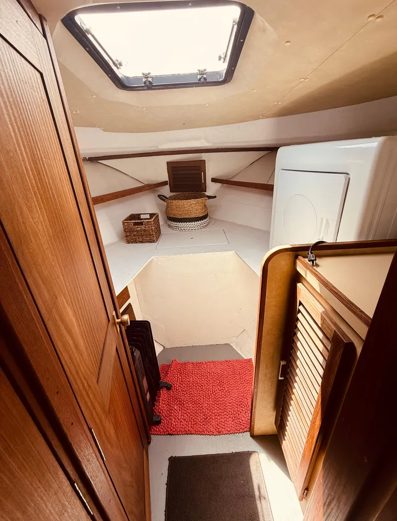 Slide: The Image of Interior of 1983 Silverton 402 Motor Yacht with wooden cabinetry and skylight. - 23