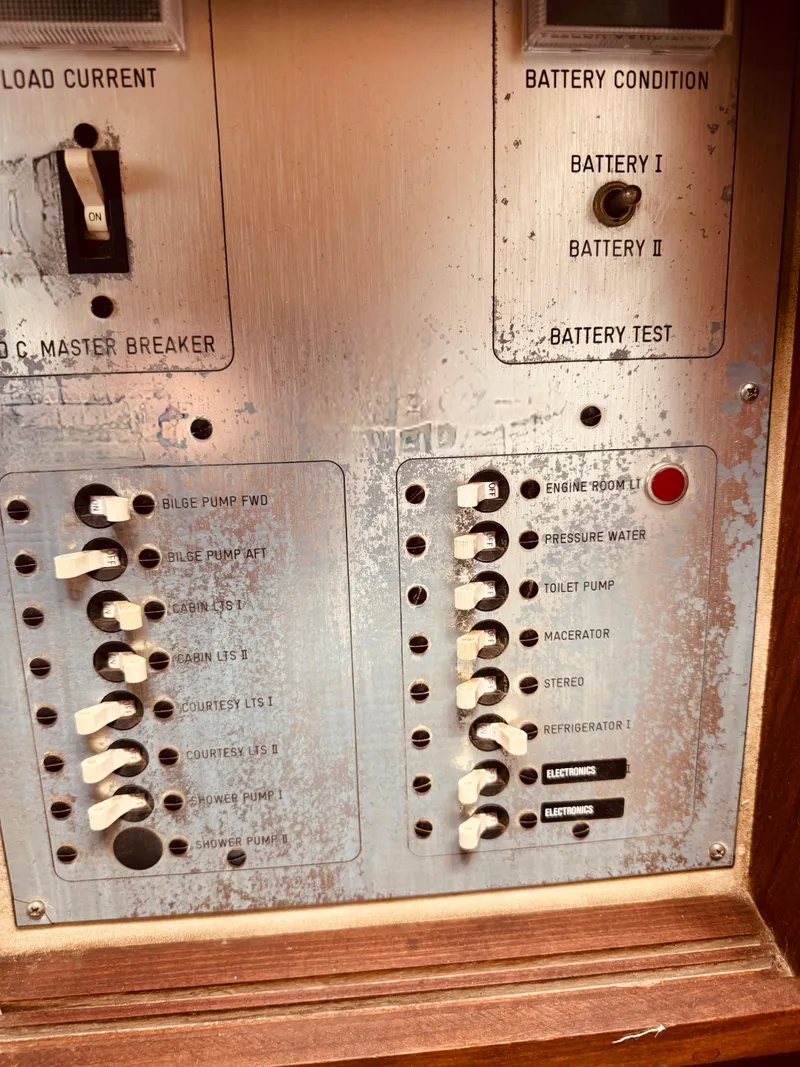 Slide: The Image of Control panel of a 1983 Silverton 402 Motor Yacht, showing switches and battery indicators. - 27
