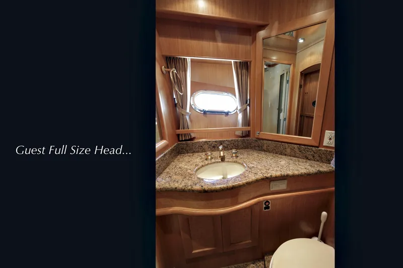 Slide: The Image of 2004 McKinna 57 Pilothouse guest bathroom with granite countertop and mirror. - 43