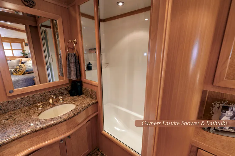 Slide: The Image of Luxurious 2004 McKinna 57 Pilothouse ensuite bathroom with granite countertop and shower. - 35