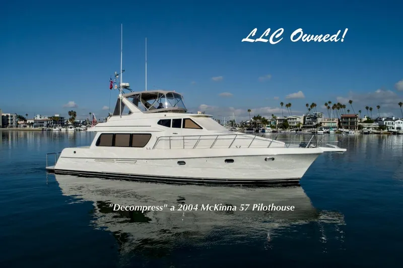 The Image of 2004 McKinna 57 Pilothouse yacht on calm water, labeled "LLC Owned." - 0