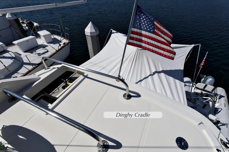Slide: The Image of 2004 McKinna 57 Pilothouse yacht with American flag and dinghy cradle. - 9