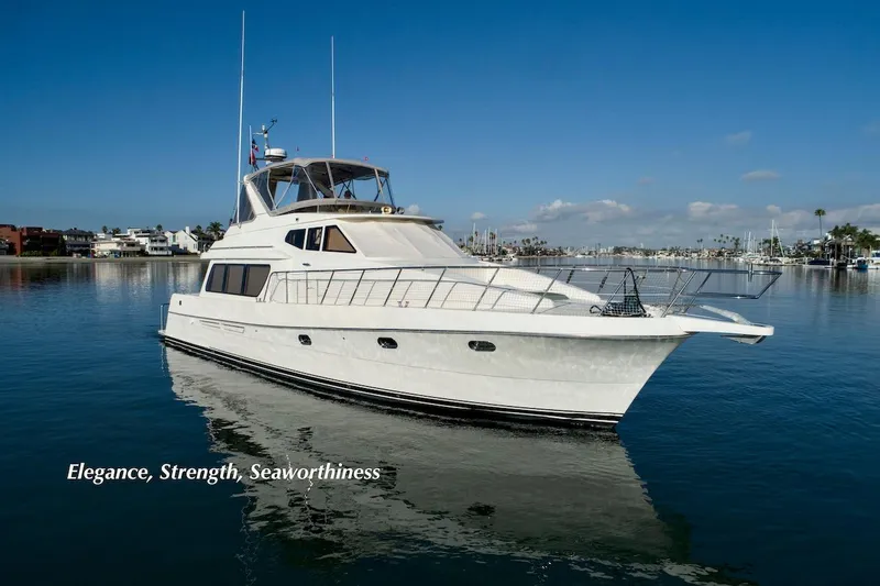 Slide: The Image of 2004 McKinna 57 Pilothouse yacht on calm water, showcasing elegance and seaworthiness. - 2