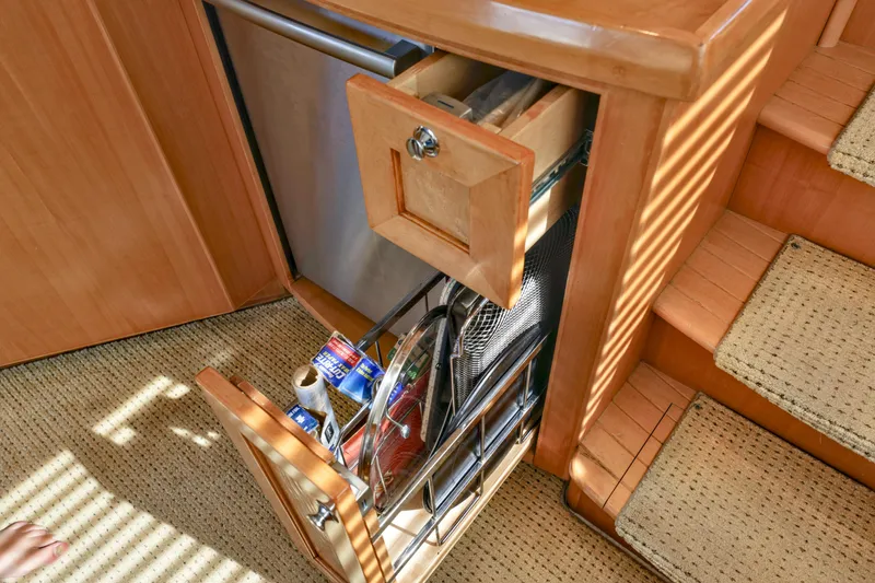 Slide: The Image of 2004 McKinna 57 Pilothouse interior with open kitchen drawer and storage. - 24