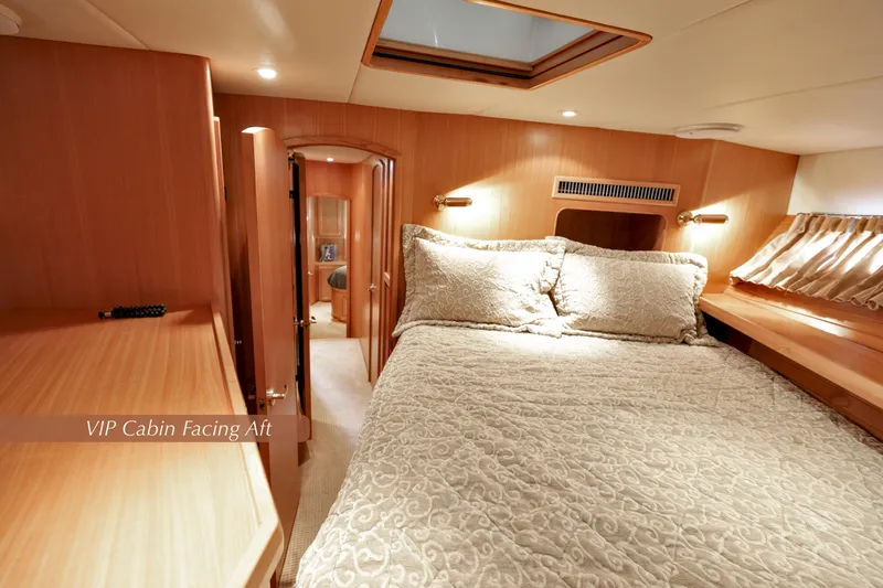Slide: The Image of VIP cabin interior of 2004 McKinna 57 Pilothouse yacht, featuring elegant bedding and wood finishes. - 36
