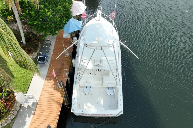 Slide: The Image of Aerial view of 2002 Cabo 35 Express boat docked by a lush garden. - 8