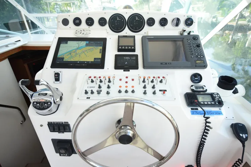 Slide: The Image of Cockpit of 2002 Cabo 35 Express boat with navigation and control instruments. - 53