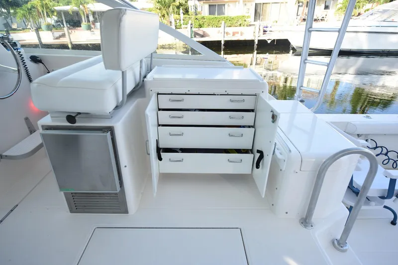 Slide: The Image of 2002 Cabo 35 Express boat interior with open storage drawers and seating. - 48