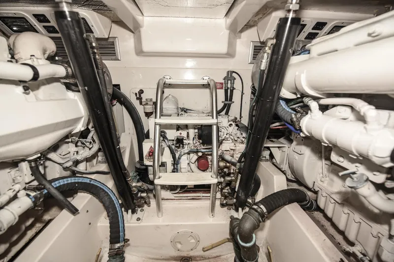 Slide: The Image of Engine room of a 2002 Cabo 35 Express boat, showcasing mechanical components and systems. - 100