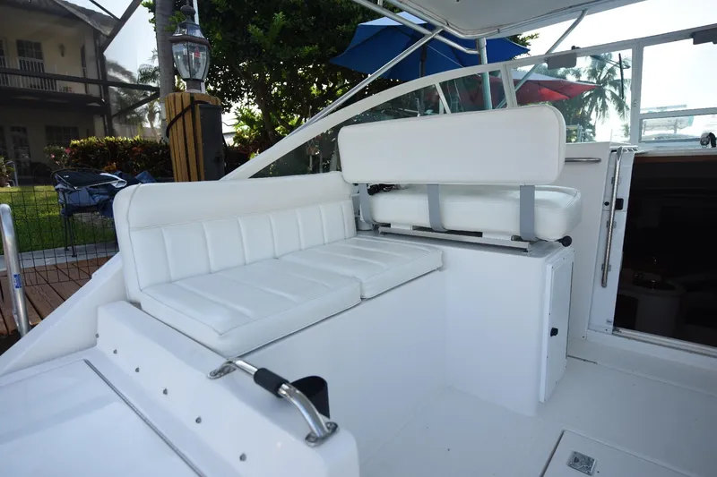 Slide: The Image of 2002 Cabo 35 Express boat interior with white seating and modern design. - 47