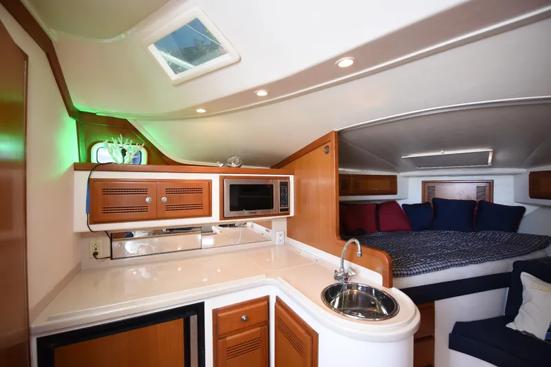 Slide: The Image of Interior of 2002 Cabo 35 Express yacht with kitchenette and cozy sleeping area. - 90