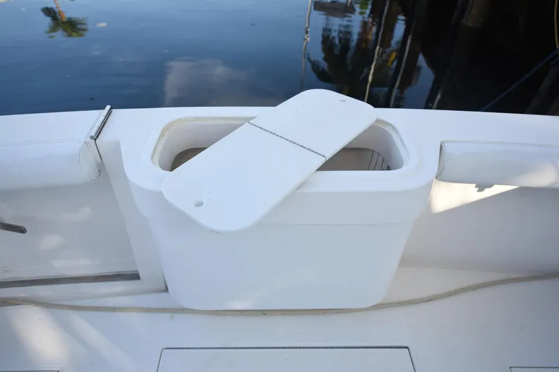 Slide: The Image of Open storage compartment on 2002 Cabo 35 Express boat deck by the water. - 17