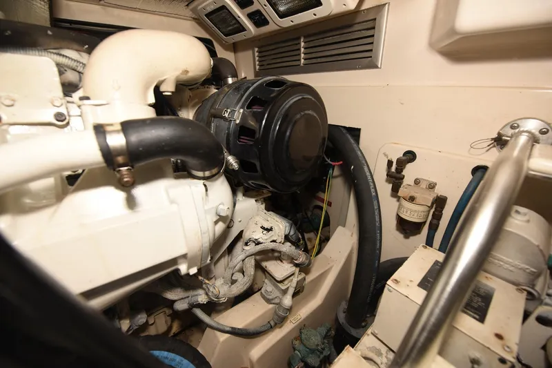 Slide: The Image of Engine compartment of a 2002 Cabo 35 Express boat, showcasing mechanical components. - 103