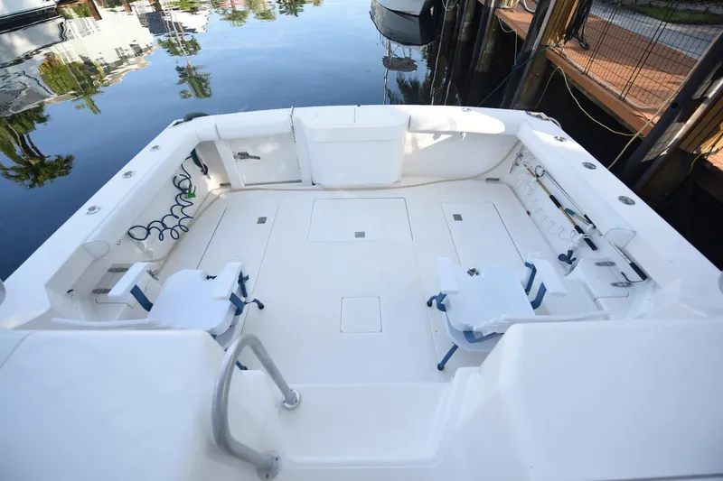 Slide: The Image of Spacious deck of 2002 Cabo 35 Express boat, featuring fishing equipment and seating. - 13