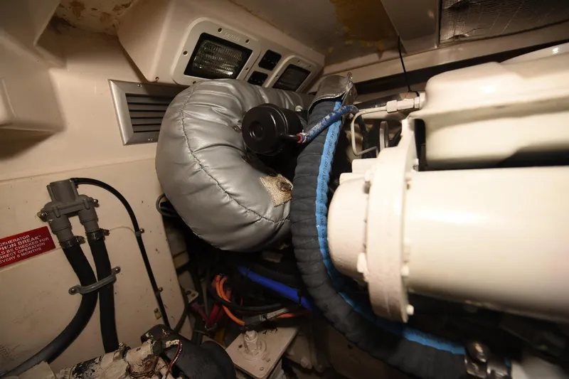 Slide: The Image of Engine room of a 2002 Cabo 35 Express boat, showcasing mechanical components. - 104