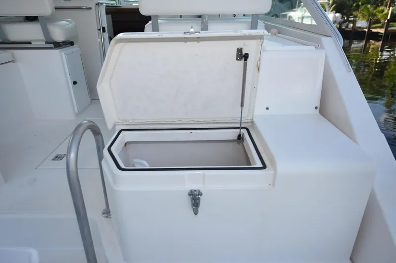 Slide: The Image of Open storage compartment on a 2002 Cabo 35 Express boat deck. - 27