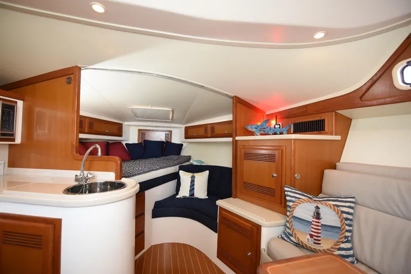 Slide: The Image of Interior of 2002 Cabo 35 Express yacht with cozy seating and nautical decor. - 74