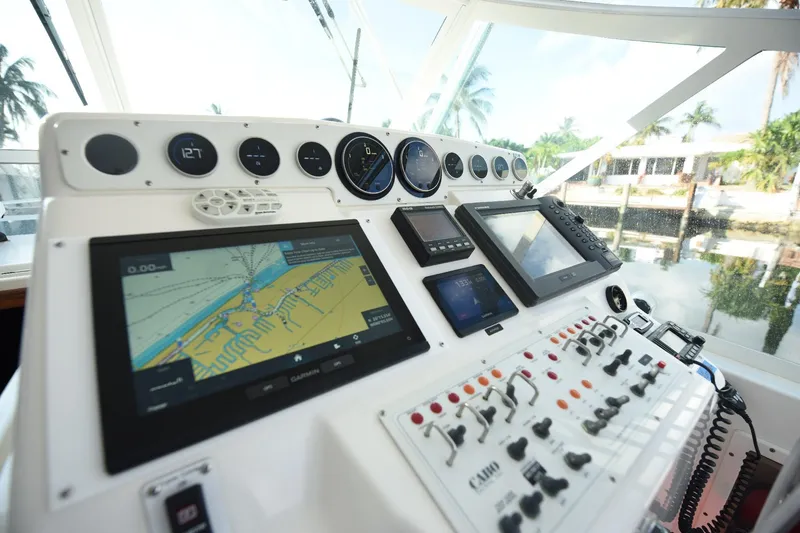 Slide: The Image of Control panel of a 2002 Cabo 35 Express boat with navigation screens and gauges. - 61