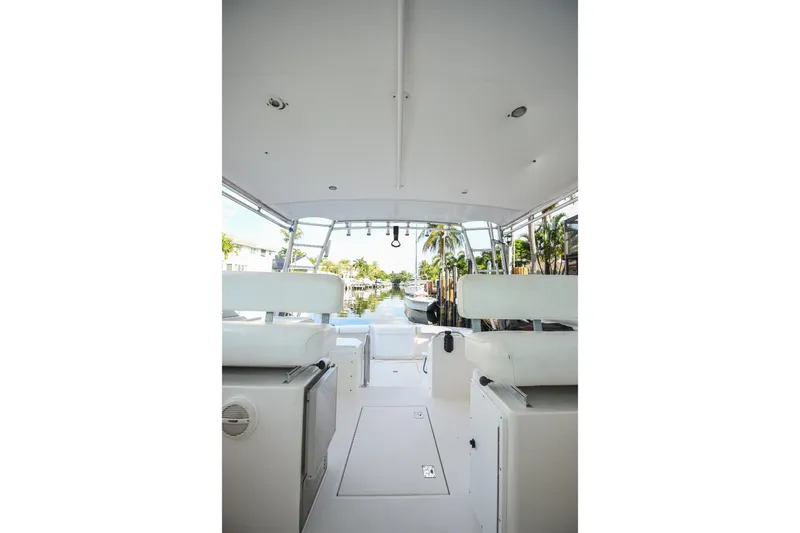 Slide: The Image of 2002 Cabo 35 Express boat interior with white seating and open deck view. - 67