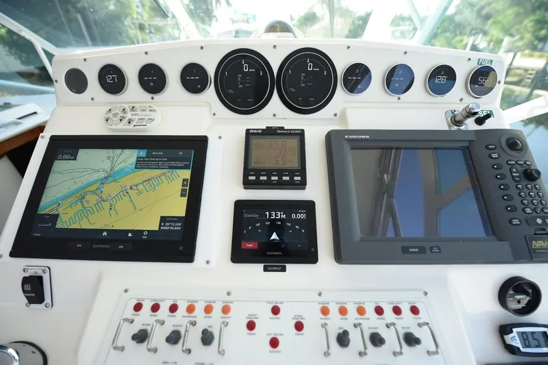 Slide: The Image of Control panel of a 2002 Cabo 35 Express boat with navigation and monitoring systems. - 59