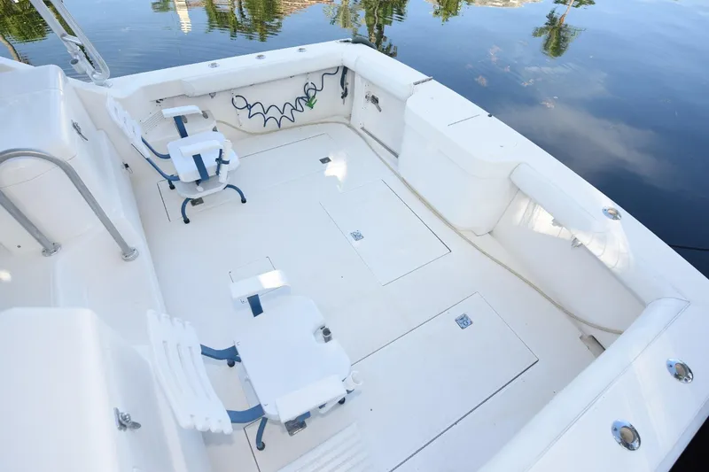 Slide: The Image of 2002 Cabo 35 Express boat deck with seating and storage compartments. - 32